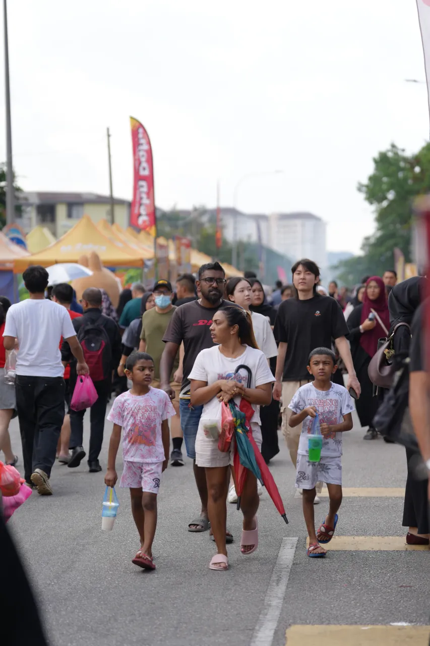 Families walking through the bazaar — colourful street scene in Wangsa Maju