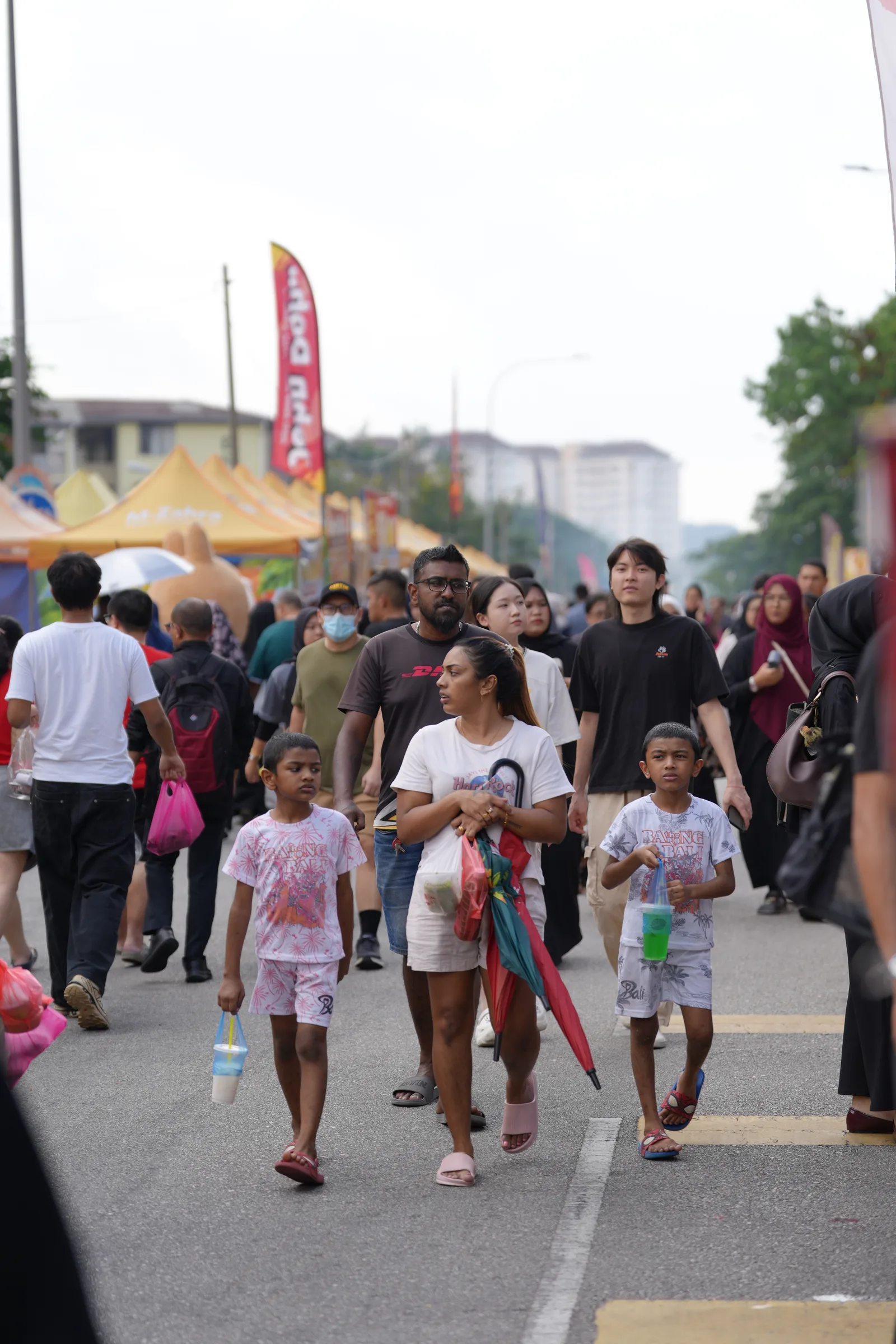 Families walking through the bazaar — colourful street scene in Wangsa Maju