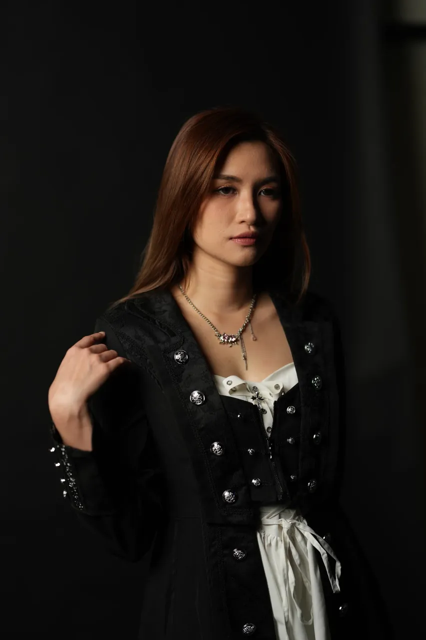 Hand to hair, low-key studio light — Kuala Lumpur portrait session