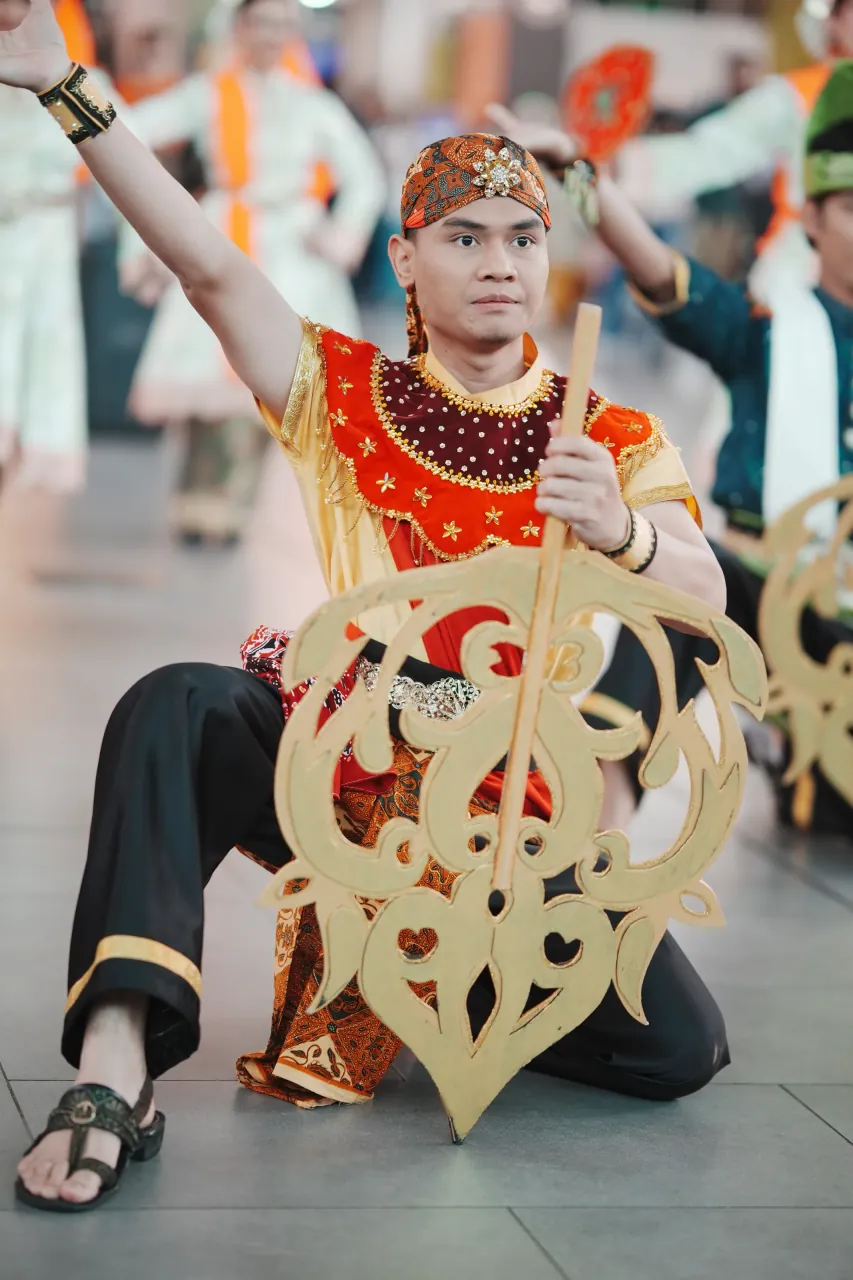 Warrior with golden shield — traditional Malay performance at KLIA2